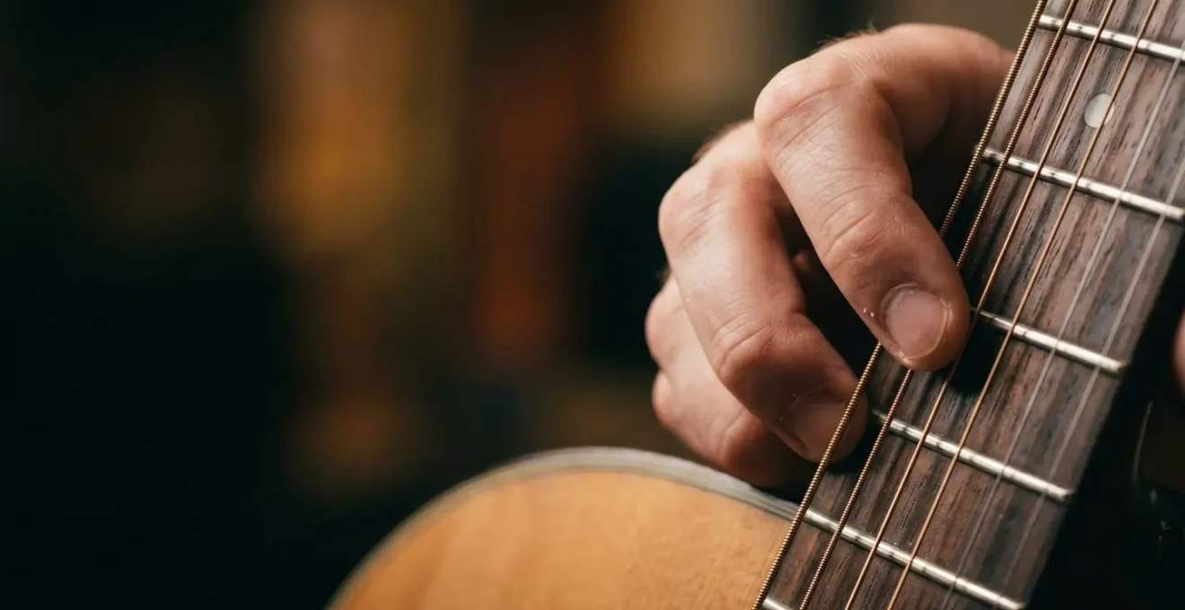 Close-up of musician's hands demonstrating delicate dynamic control and gentle playing technique
