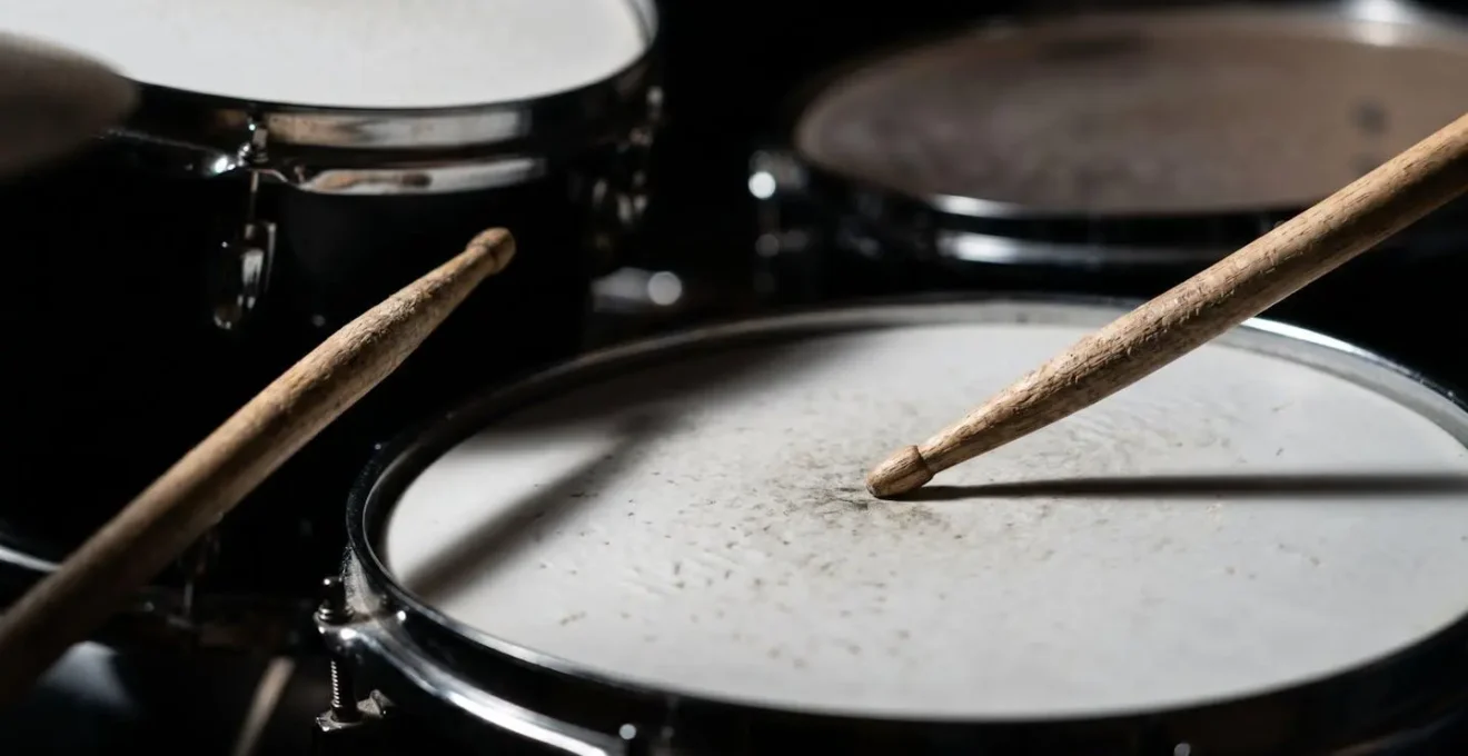 Macro close-up of drumsticks executing a linear pattern across drums showing the one-voice-at-a-time principle