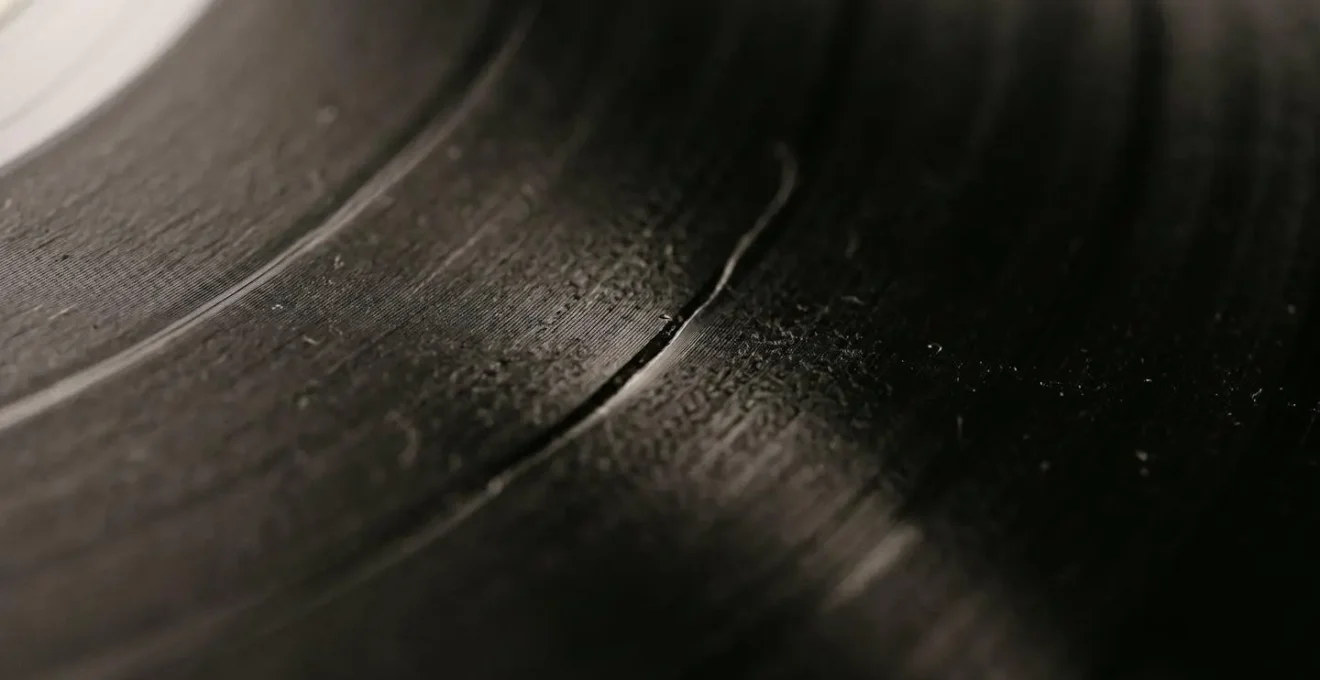 Extreme close-up of vinyl record groove showing tactile surface texture and manufacturing quality detail
