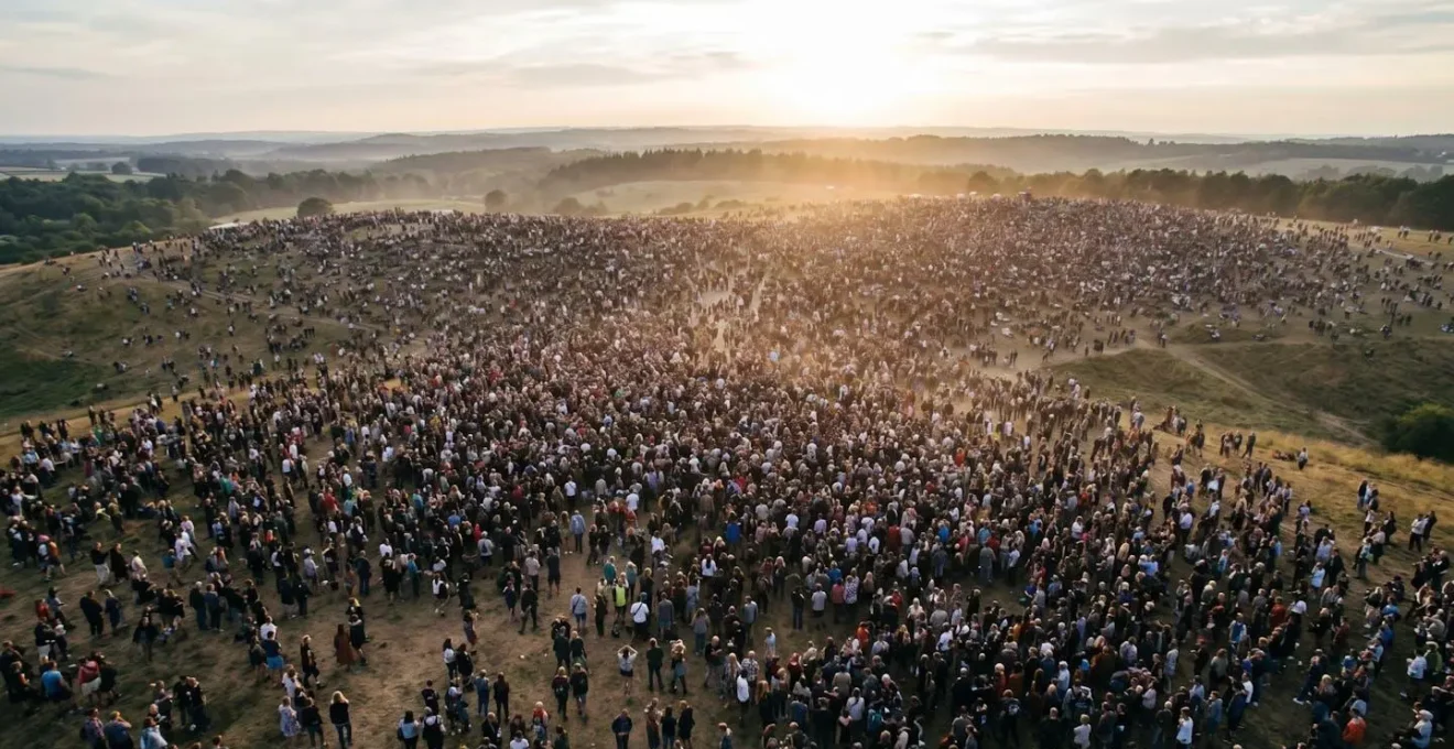 Vast outdoor festival crowd extending to the horizon, symbolizing the formation of a temporary countercultural community.