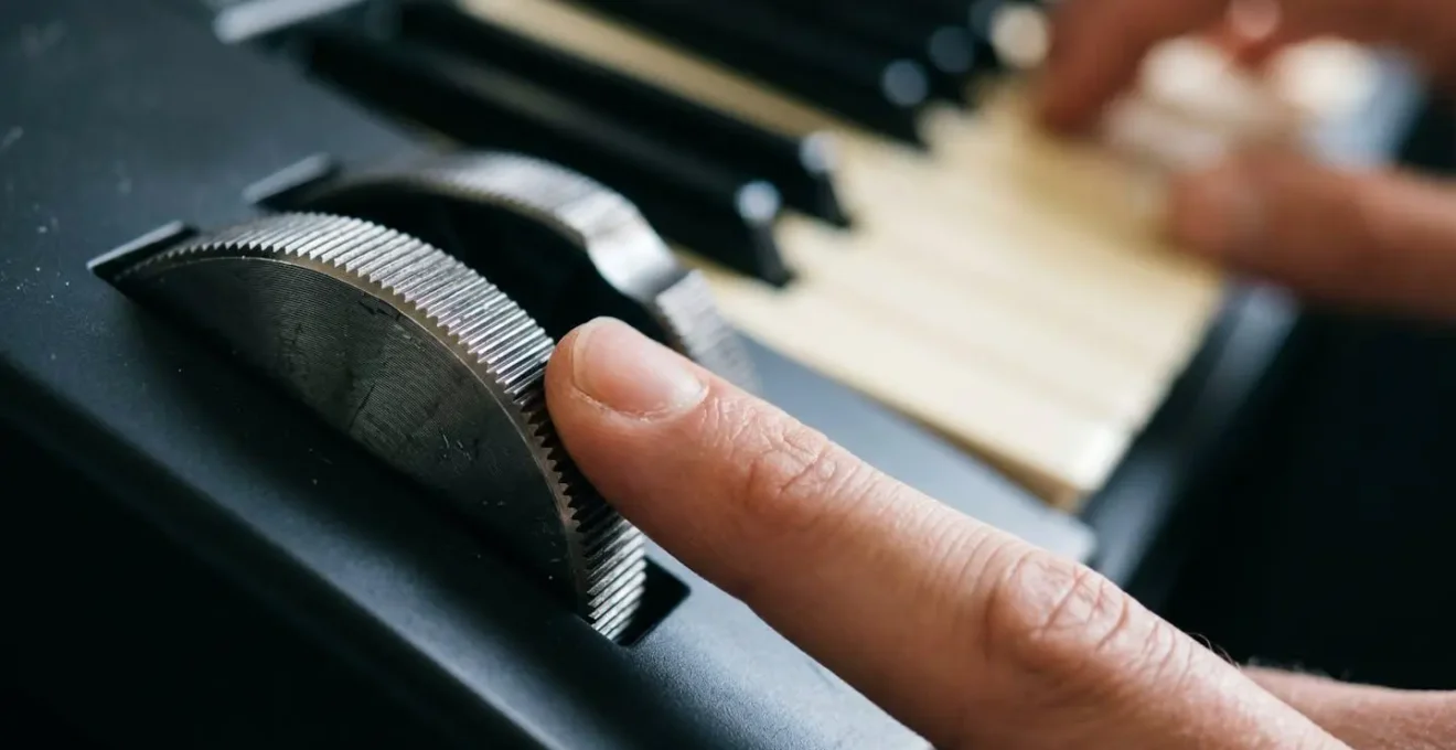 Extreme close-up macro shot of a MIDI controller's modulation wheel, showing the tactile detail of controlling musical expression.