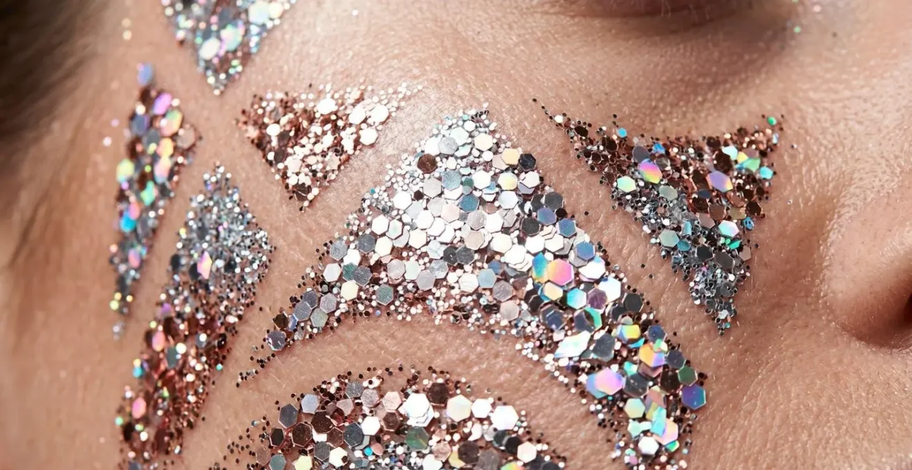 Extreme close-up of layered glitter particles showing texture and depth with varying sizes and finishes